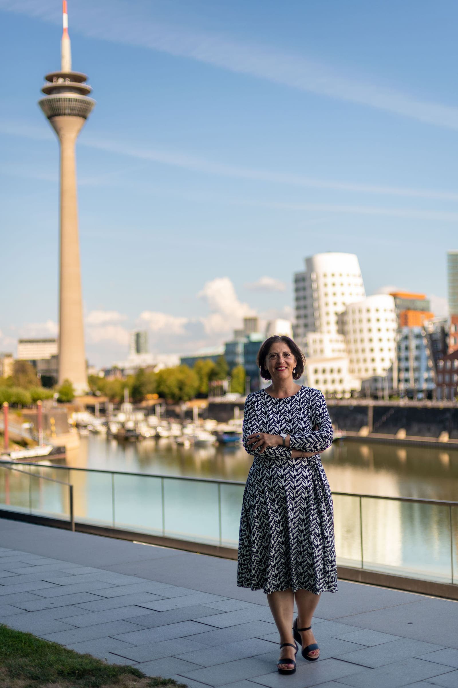Martha Giannakoudi im Düsseldorfer Medienhafen mit Rheinturm — Synnous Consulting